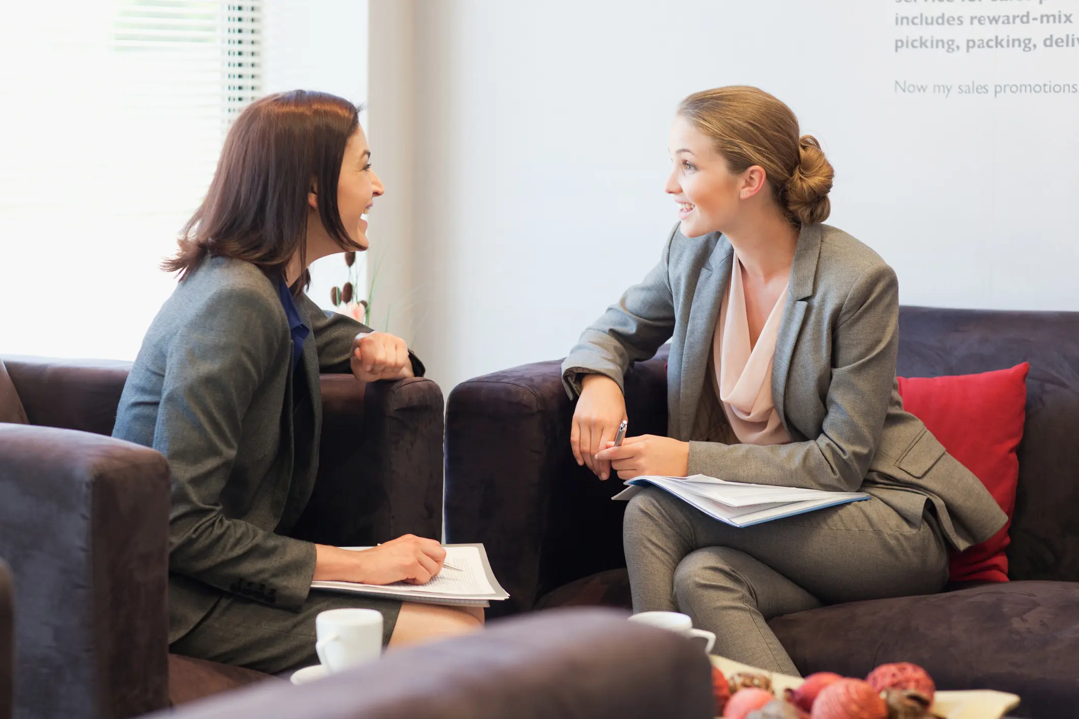 Business people talking face to face in lobby